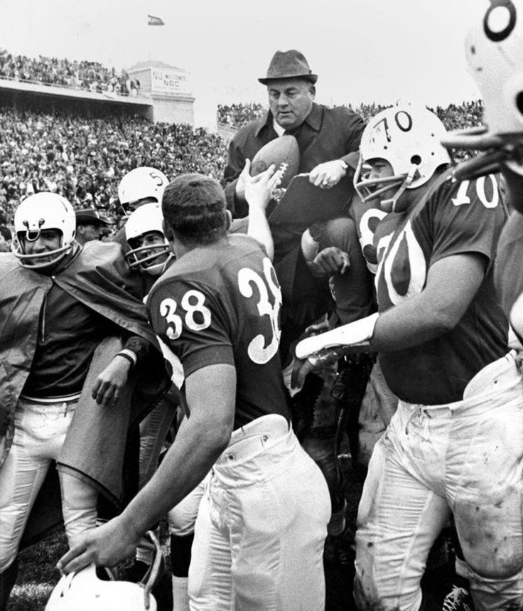 In 1965, Rick Haasch handed the game ball to Coach Bob Devaney after Nebraska finished the regular season undefeated for the first time in fifty years, defeating Oklahoma 21-9 to secure their third straight conference title.